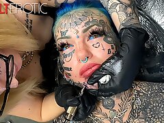 Jaw-dropping doll decorated in tattoos gets another tattoo on her face