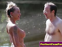 Buxom femdom tugging guy outdoors for jism
