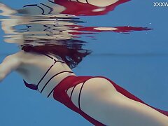 Petite Russian Marfa swims nude in the pool