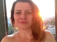 Horny Cougar wiggles her ass on the balcony, fucks herself with a dildo, squir